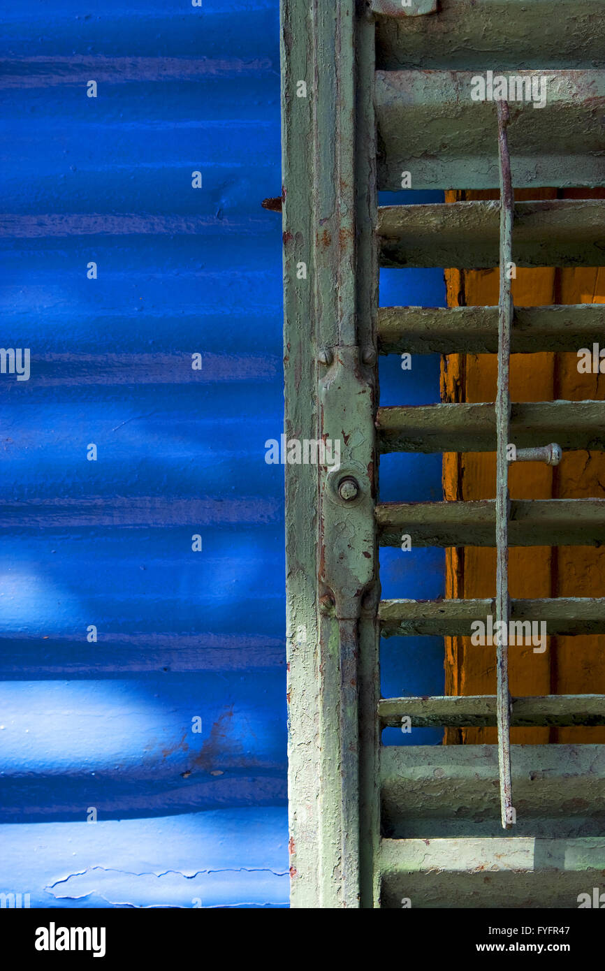 green iron blind and a blue metal wall Stock Photo Alamy