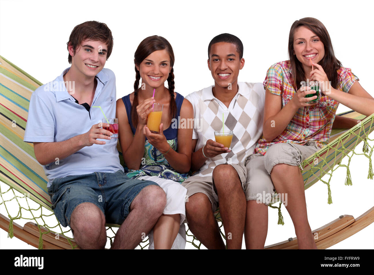 A bunch of friends enjoying cocktails on a hammock. Stock Photo