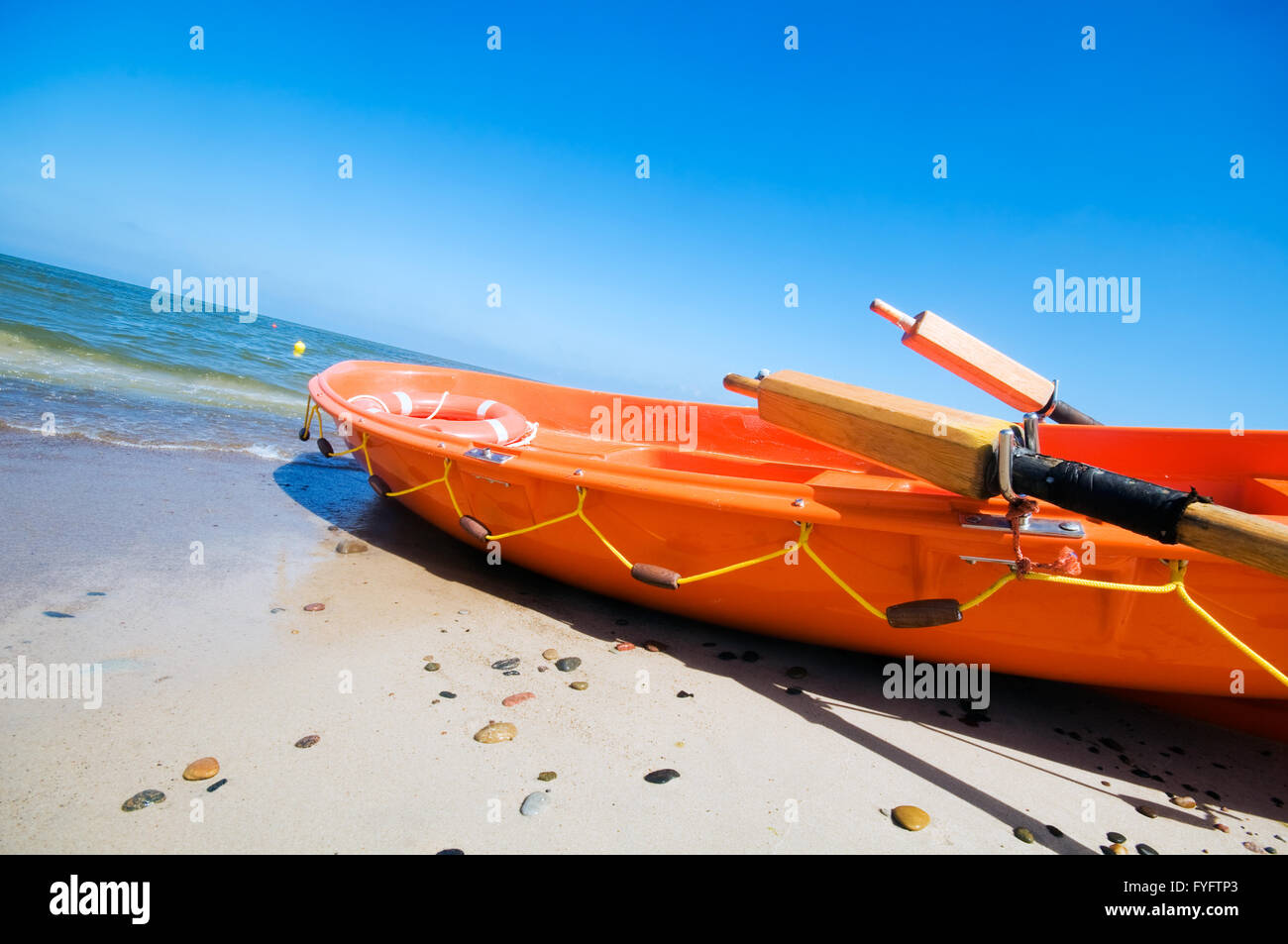 Orange rescue boat by the sea Stock Photo - Alamy