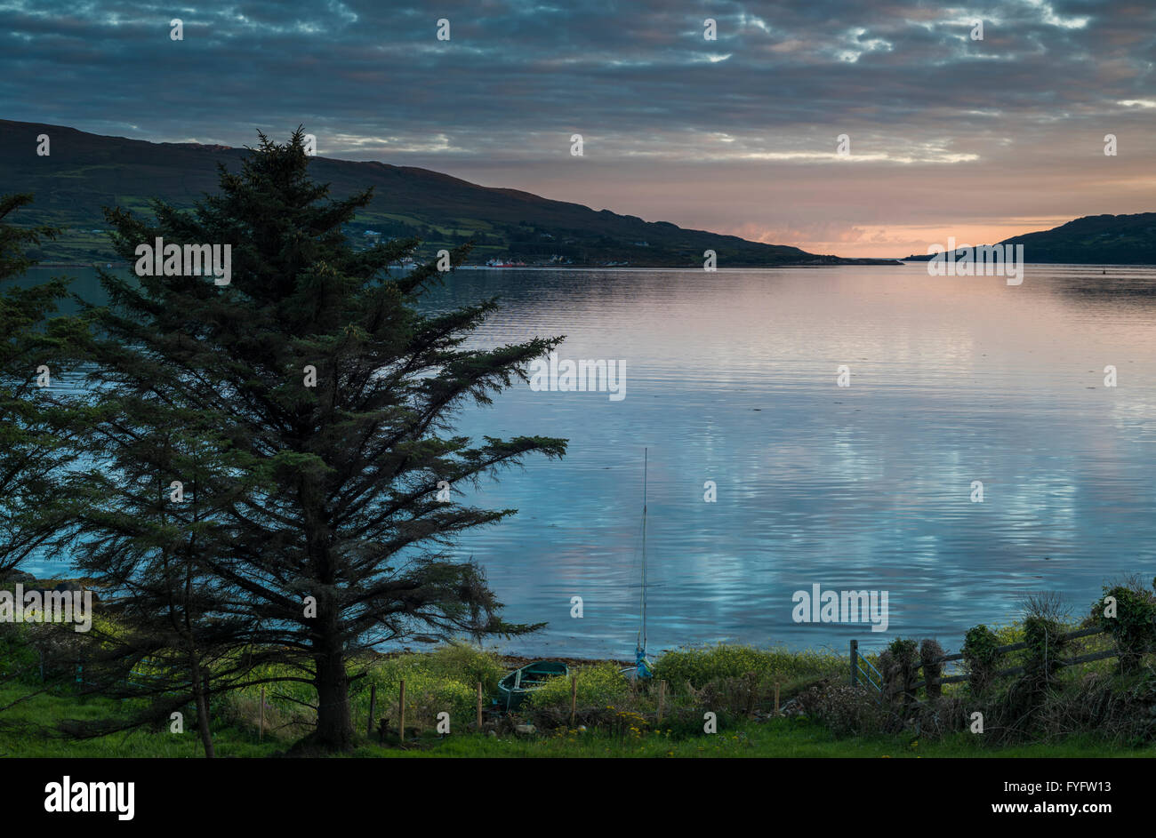 View westward at sunset towards the mouth of Bantry Bay between the mainland and Bere Island from Castletownbere, County Cork Stock Photo
