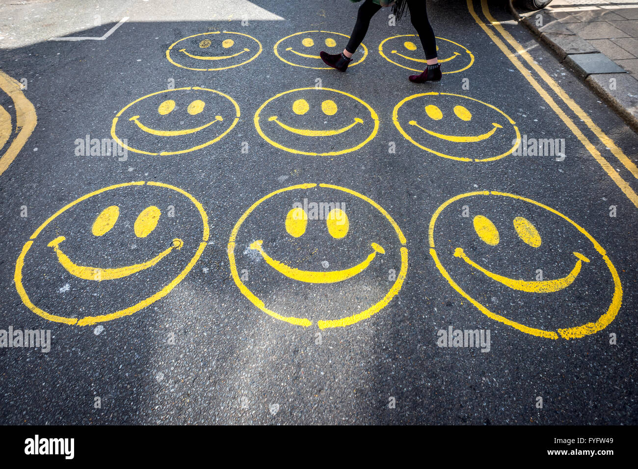 Smiley faces painted onto the road in Brighton. Stock Photo