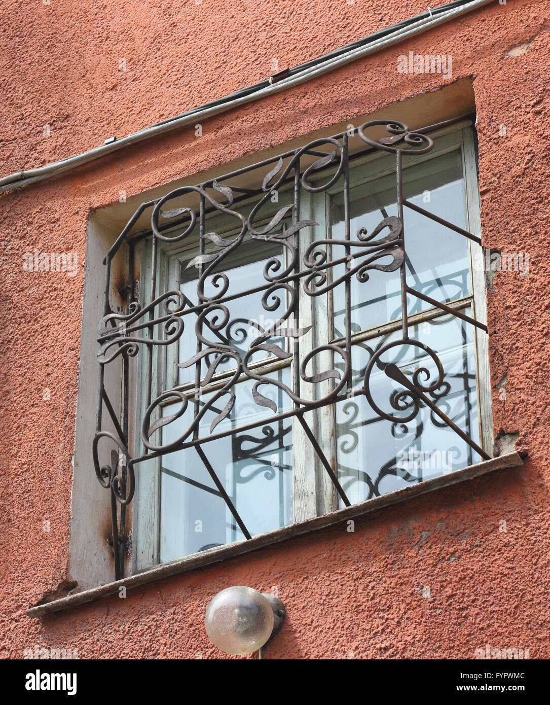 metal forged carved lattice at a plastic white window Stock Photo
