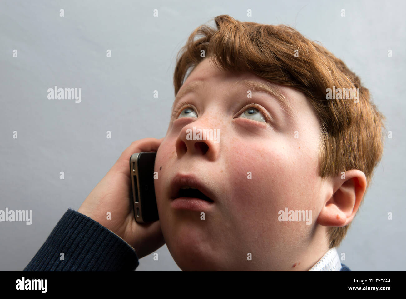 Young boy using mobile phone Stock Photo