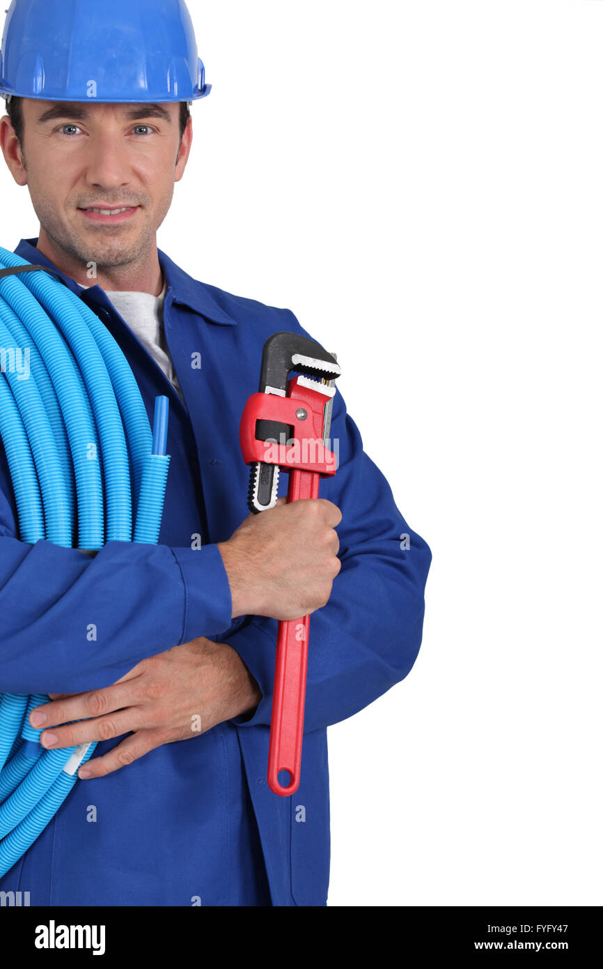 Closeup of an electrician with roll of blue cable and a wrench Stock Photo
