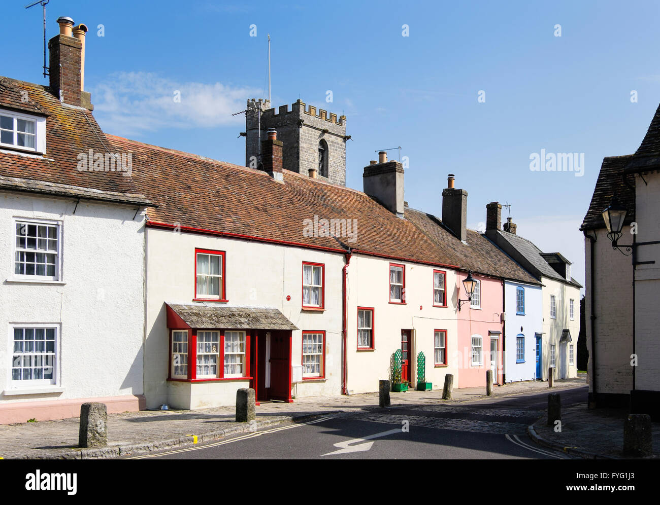 Row of pretty cottages in Wareham, Dorset with the Church of Lady St Mary in the background Stock Photo