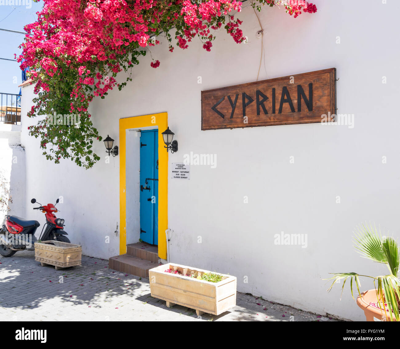 NORTH CYPRUS KYRENIA OLD TOWN BOUGAINVILLEA ON A WALL AND COLOURFUL DOORWAY INTO CYPRIAN Stock Photo