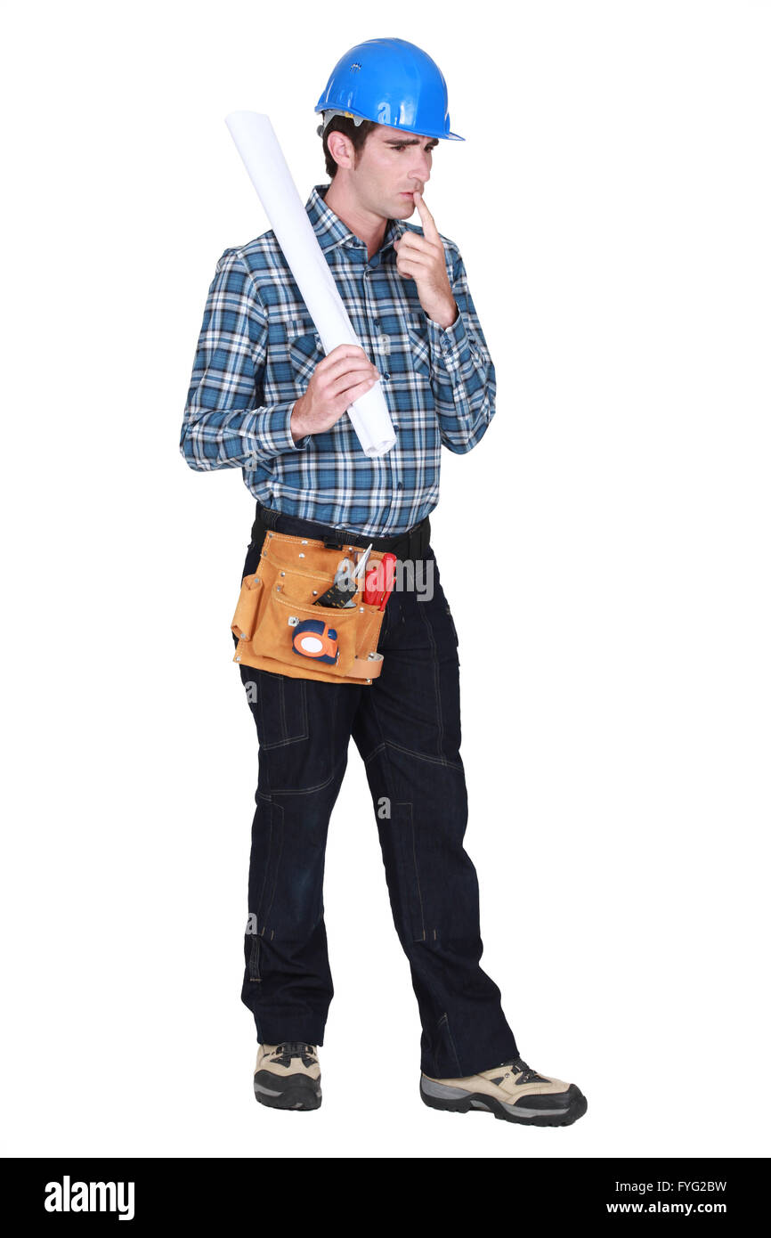 full-length portrait of carpenter looking puzzled Stock Photo