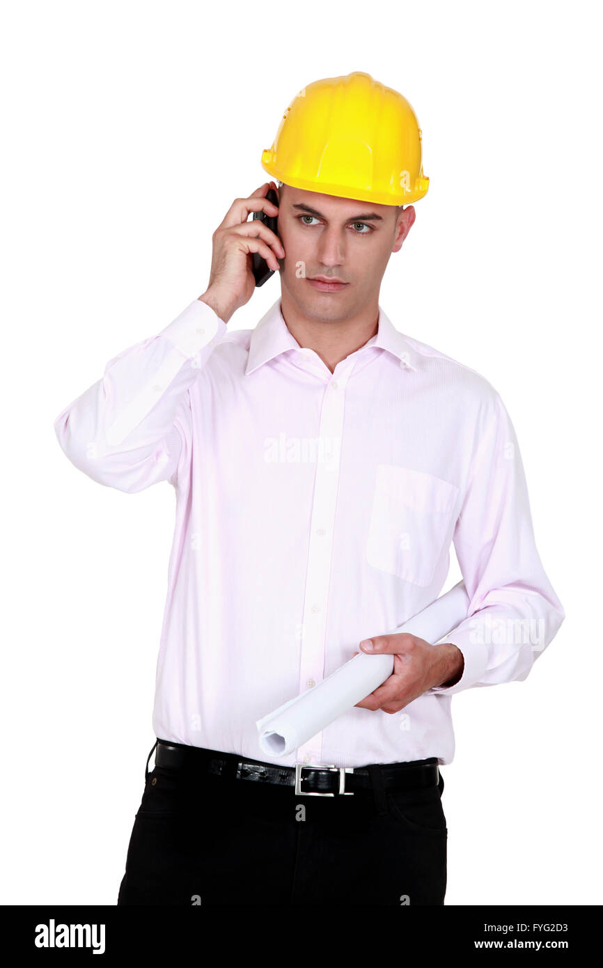 businessman wearing helmet and talking on the phone Stock Photo