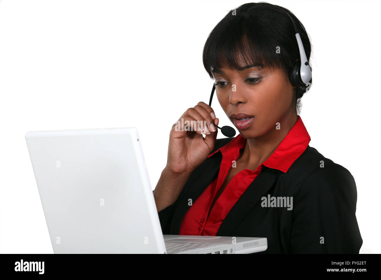 Businesswoman wearing a headset with a laptop Stock Photo