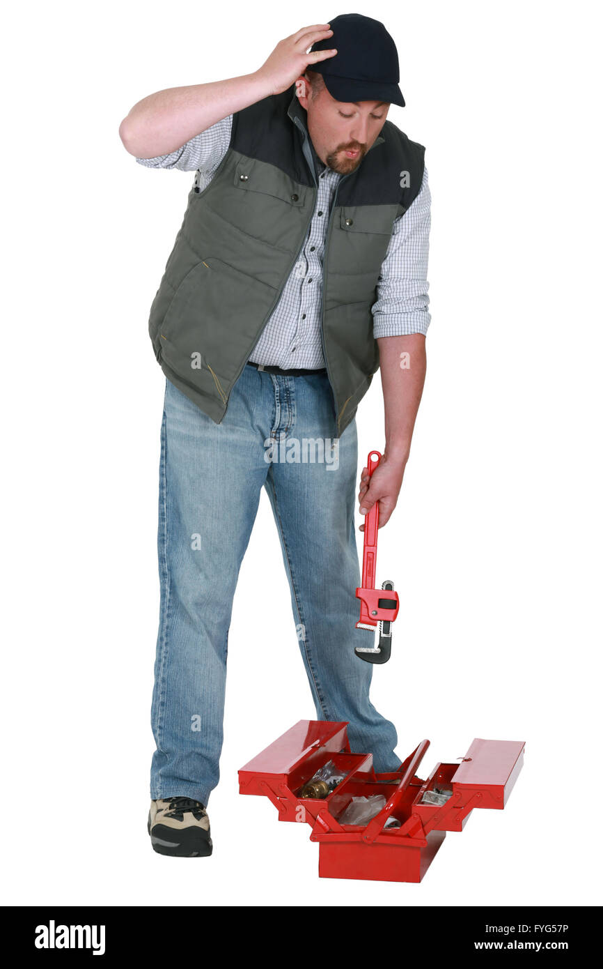 Handyman looking for a lost object in his toolbox Stock Photo