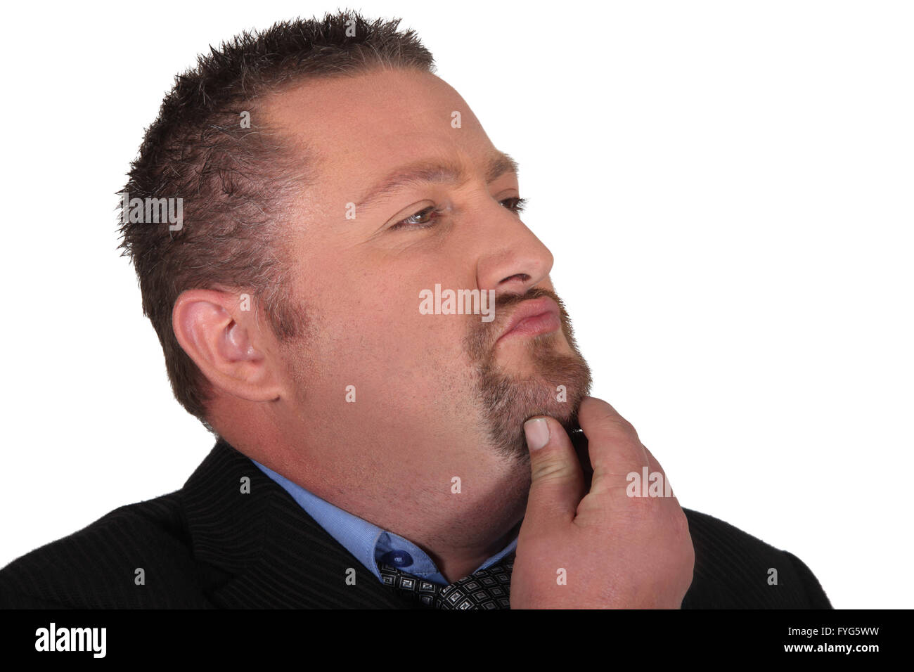 Businessman stroking his beard whilst thinking Stock Photo