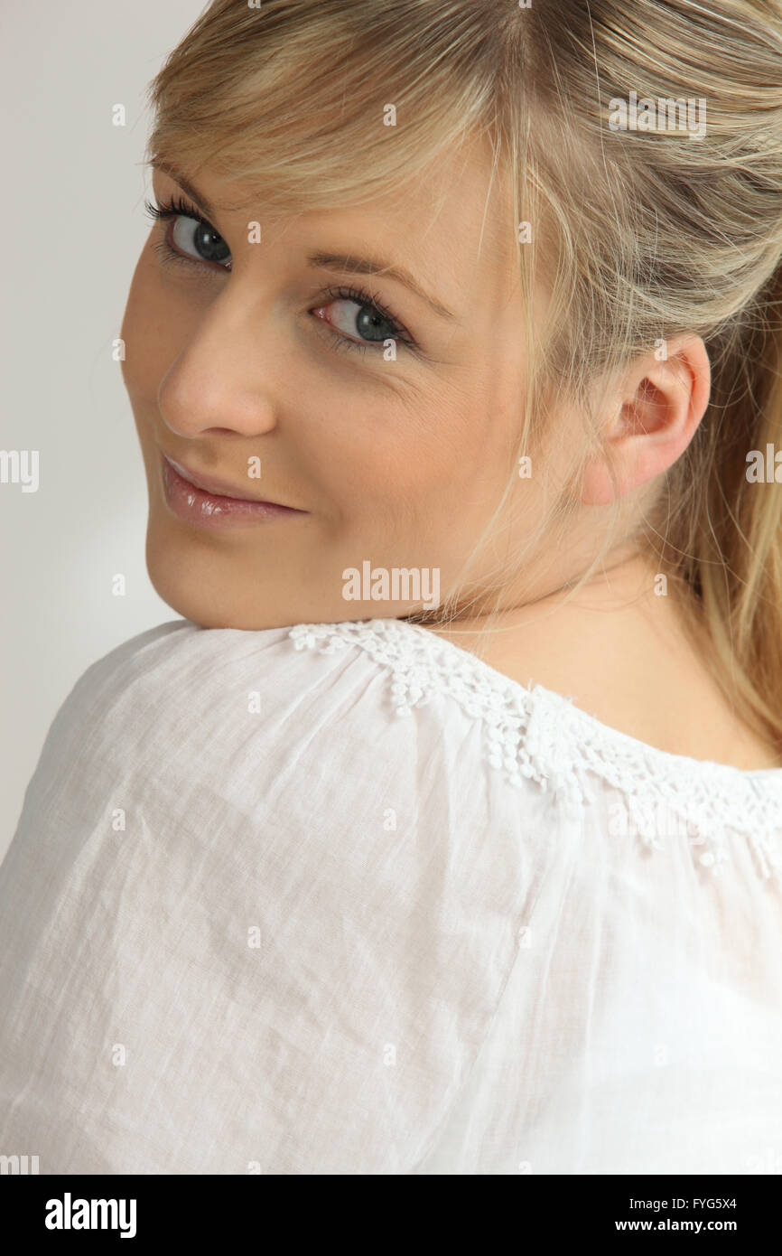 Romantic woman looking coyly over her shoulder Stock Photo