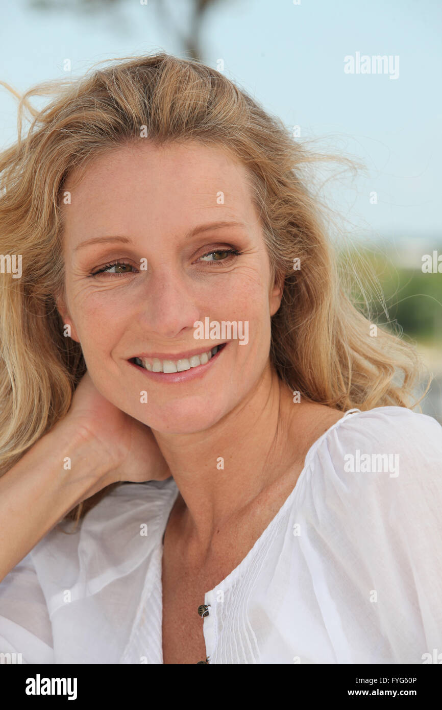 Carefree woman relaxing on a sunny breezy day Stock Photo