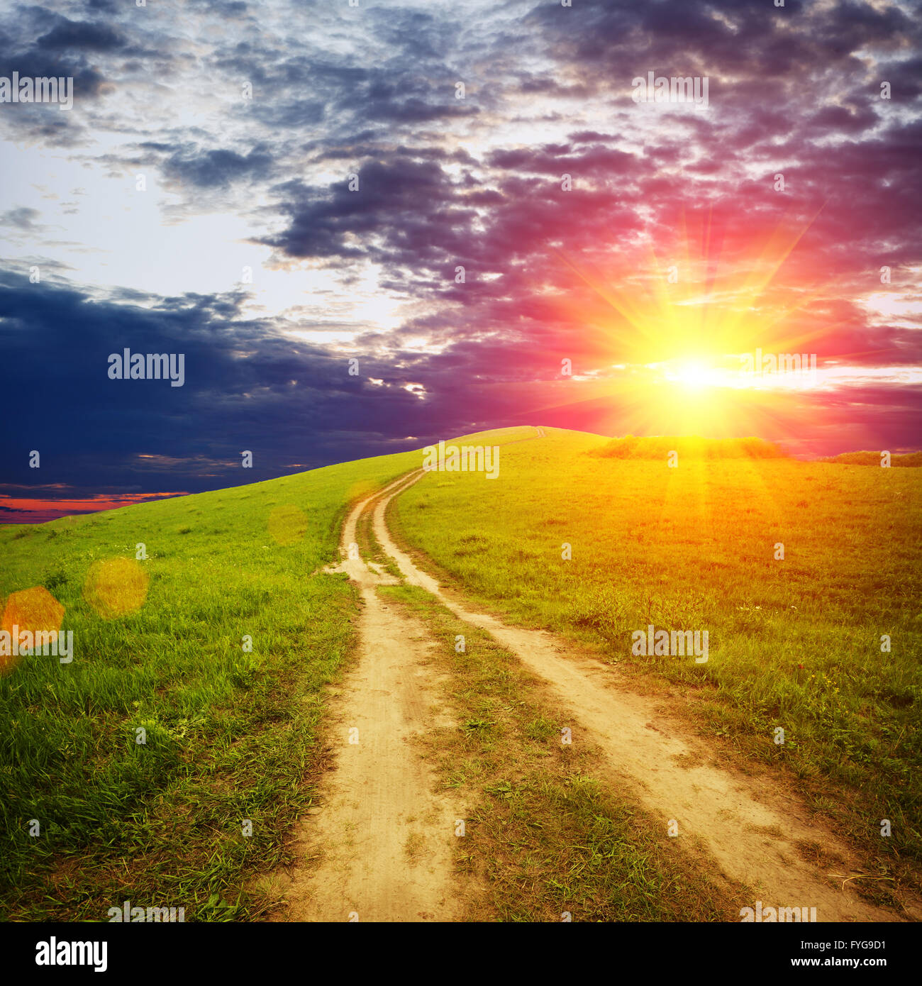 Road in field and stormy clouds Stock Photo - Alamy
