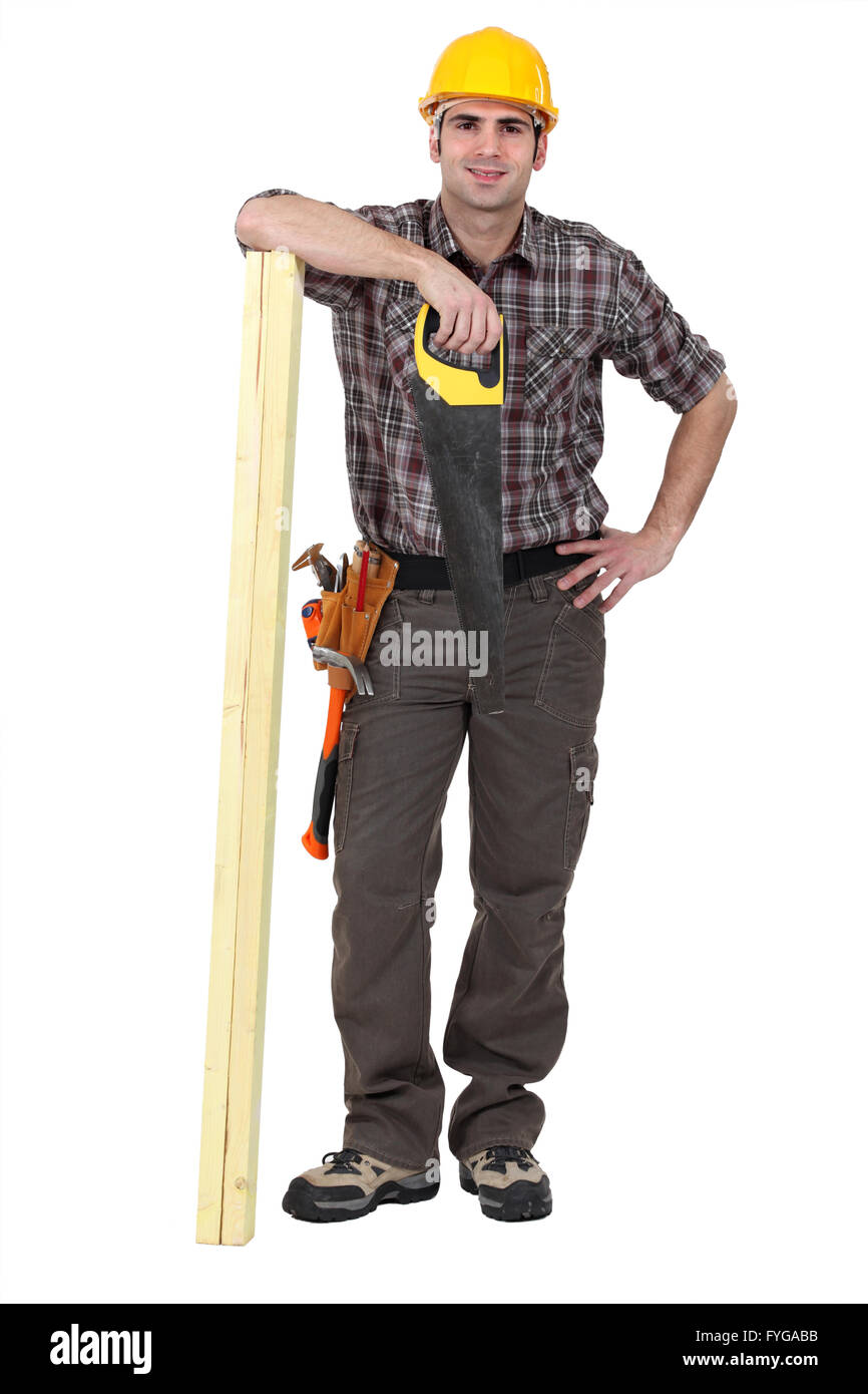 Tradesman posing with his tools and building materials Stock Photo