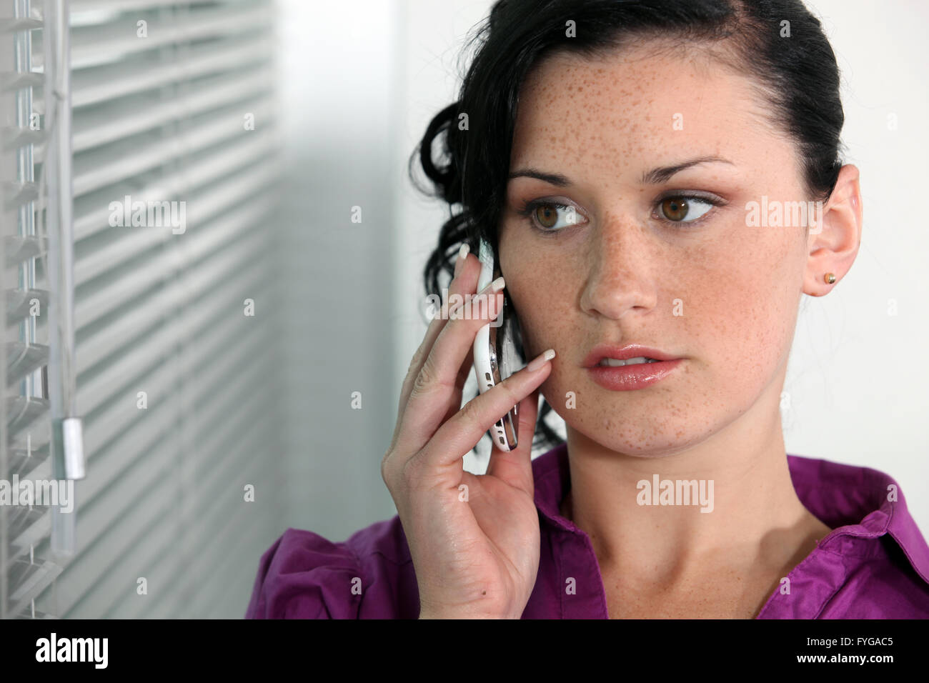 Attractive young woman talking on her mobile phone Stock Photo