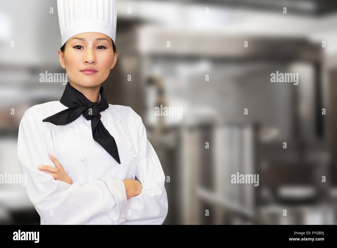 Composite image of portrait of confident female cook in kitchen Stock Photo