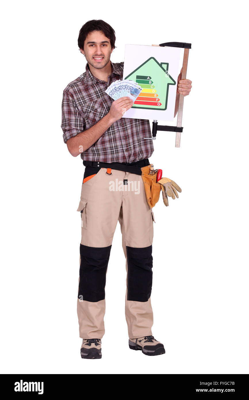 electrician standing in studio with bank notes Stock Photo