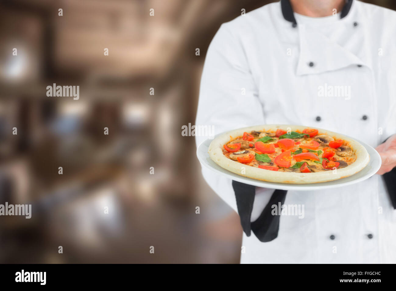 Composite image of male chef offering pizza Stock Photo
