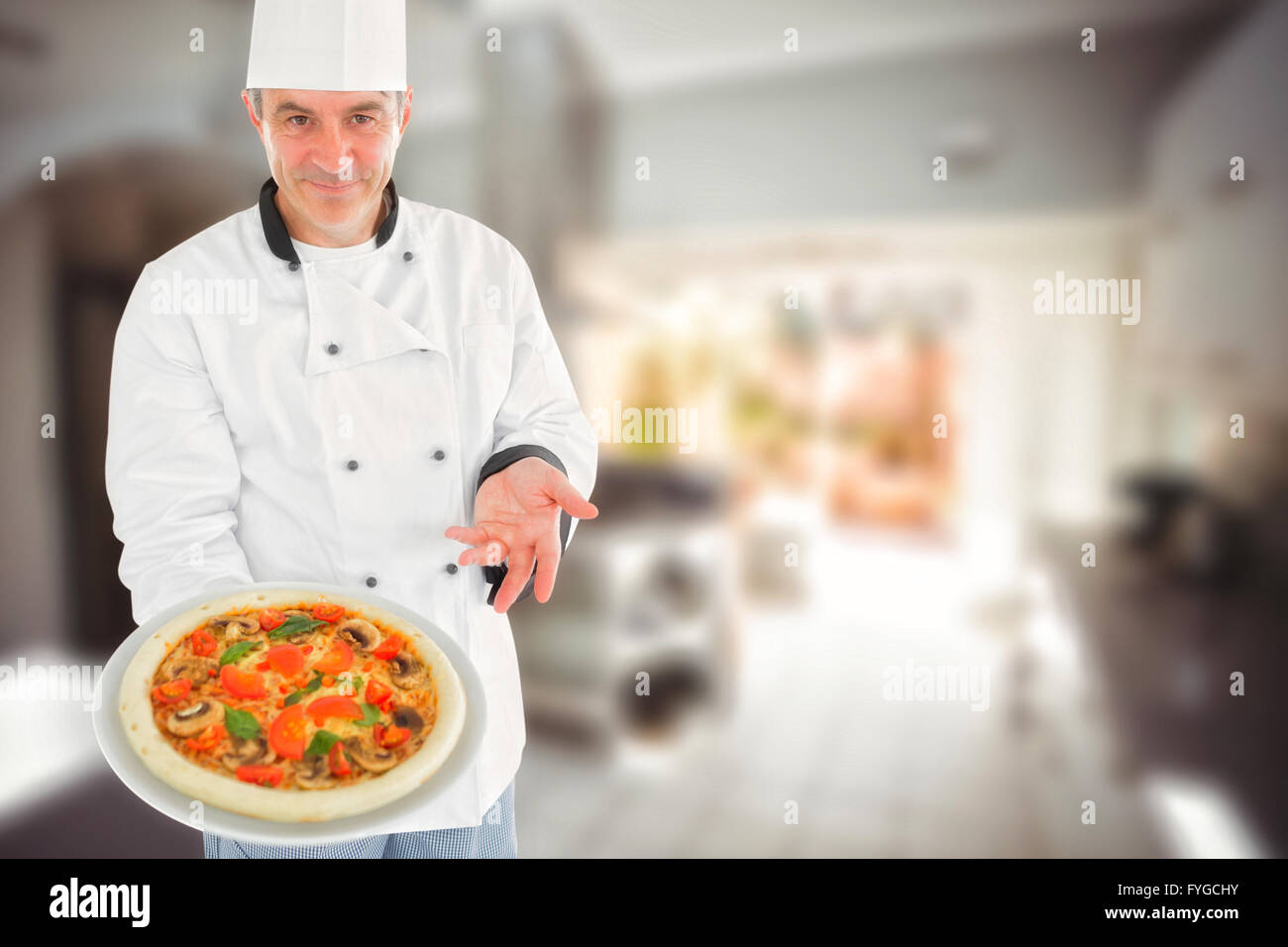 Composite image of chef displaying delicious pizza Stock Photo
