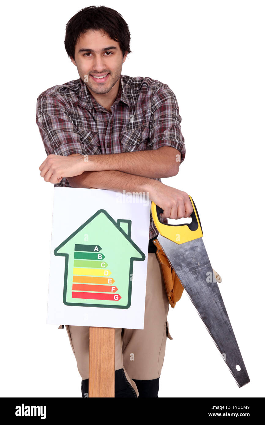 Builder with a saw and house energy rating sign Stock Photo