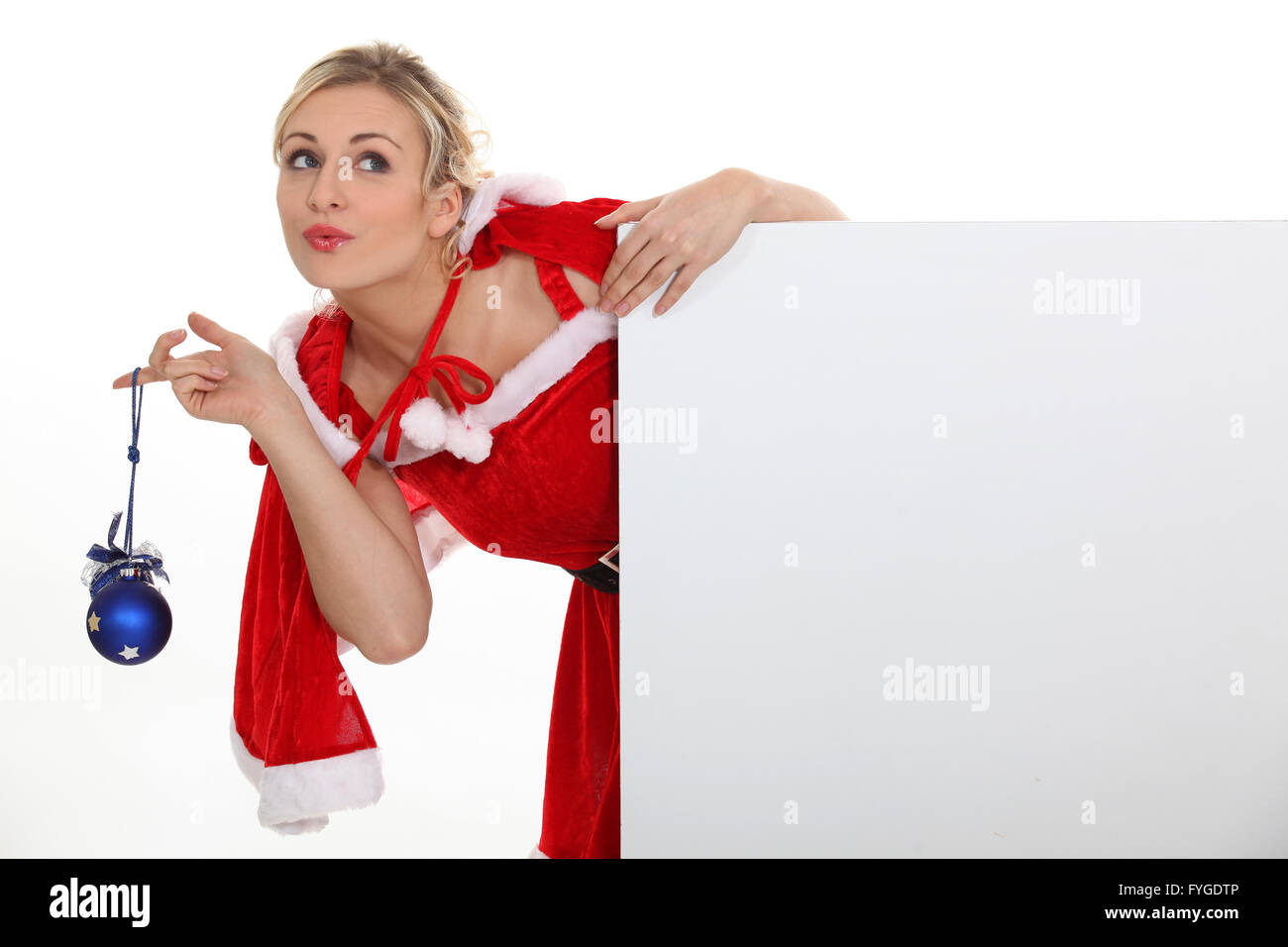 Woman dressed as Mrs. Claus and holding a blank board Stock Photo