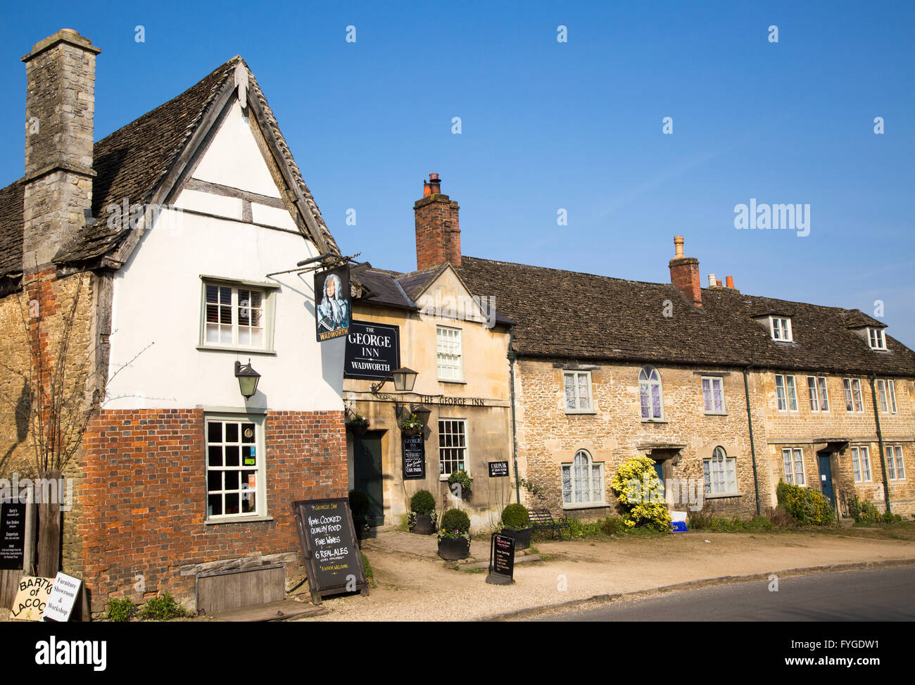 Historic houses and The George Inn at the  village of Lacock, Wiltshire, England, UK Stock Photo