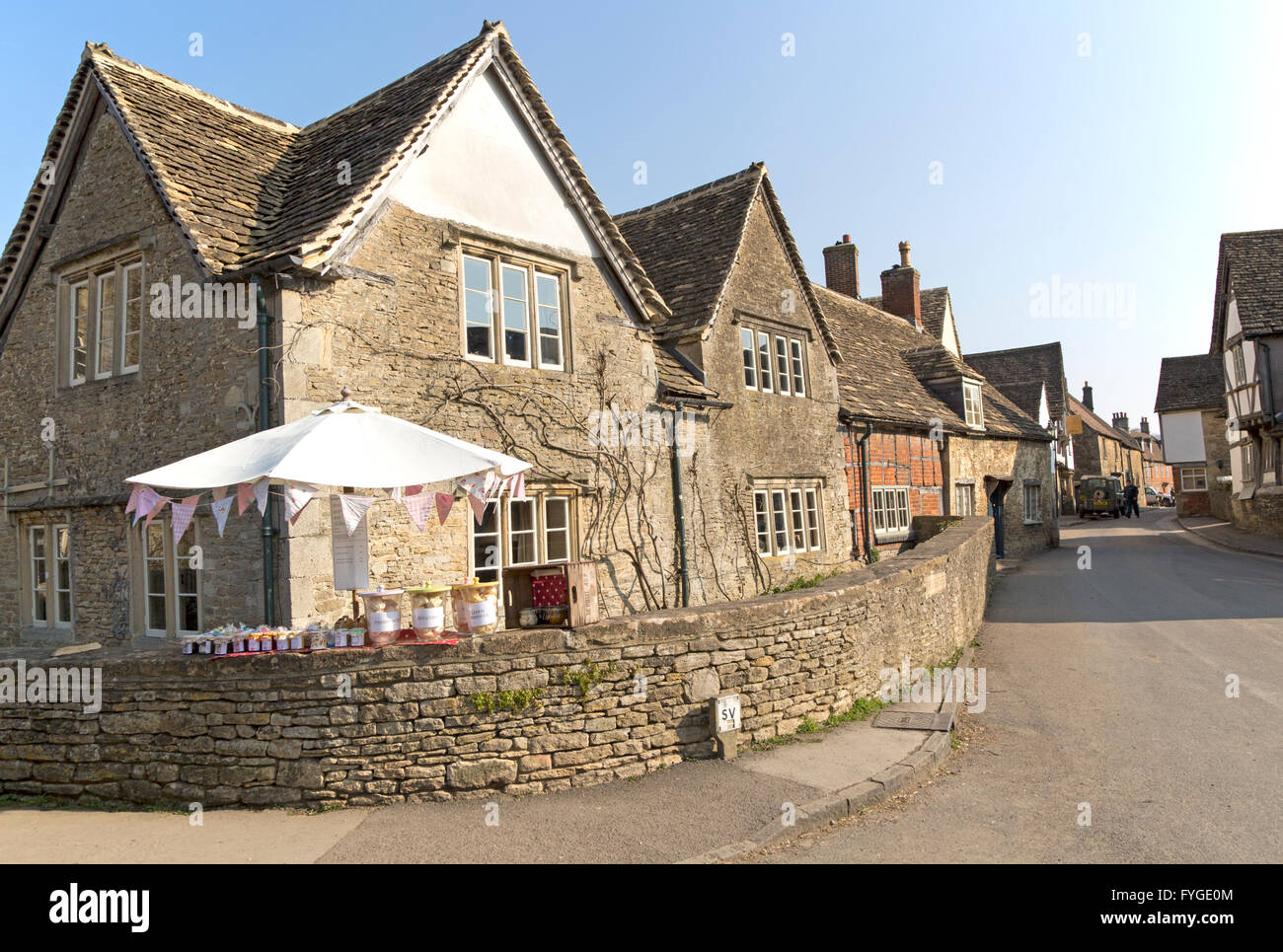 Garden produce stall and street in the village of Lacock, Wiltshire, England, UK Stock Photo