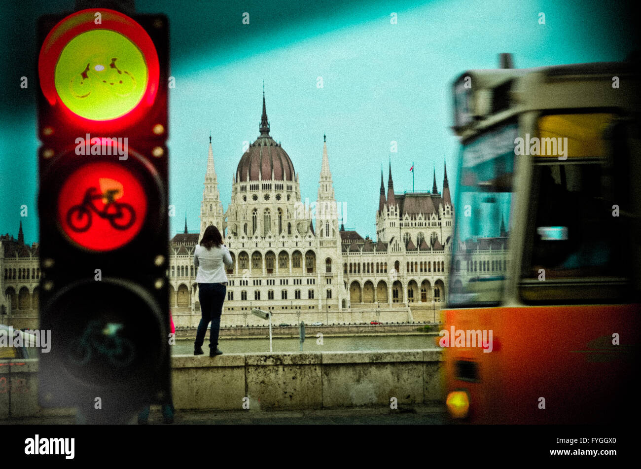 Girl taking pictures to the Parlament in Budapest, while the tram is passing. Stock Photo