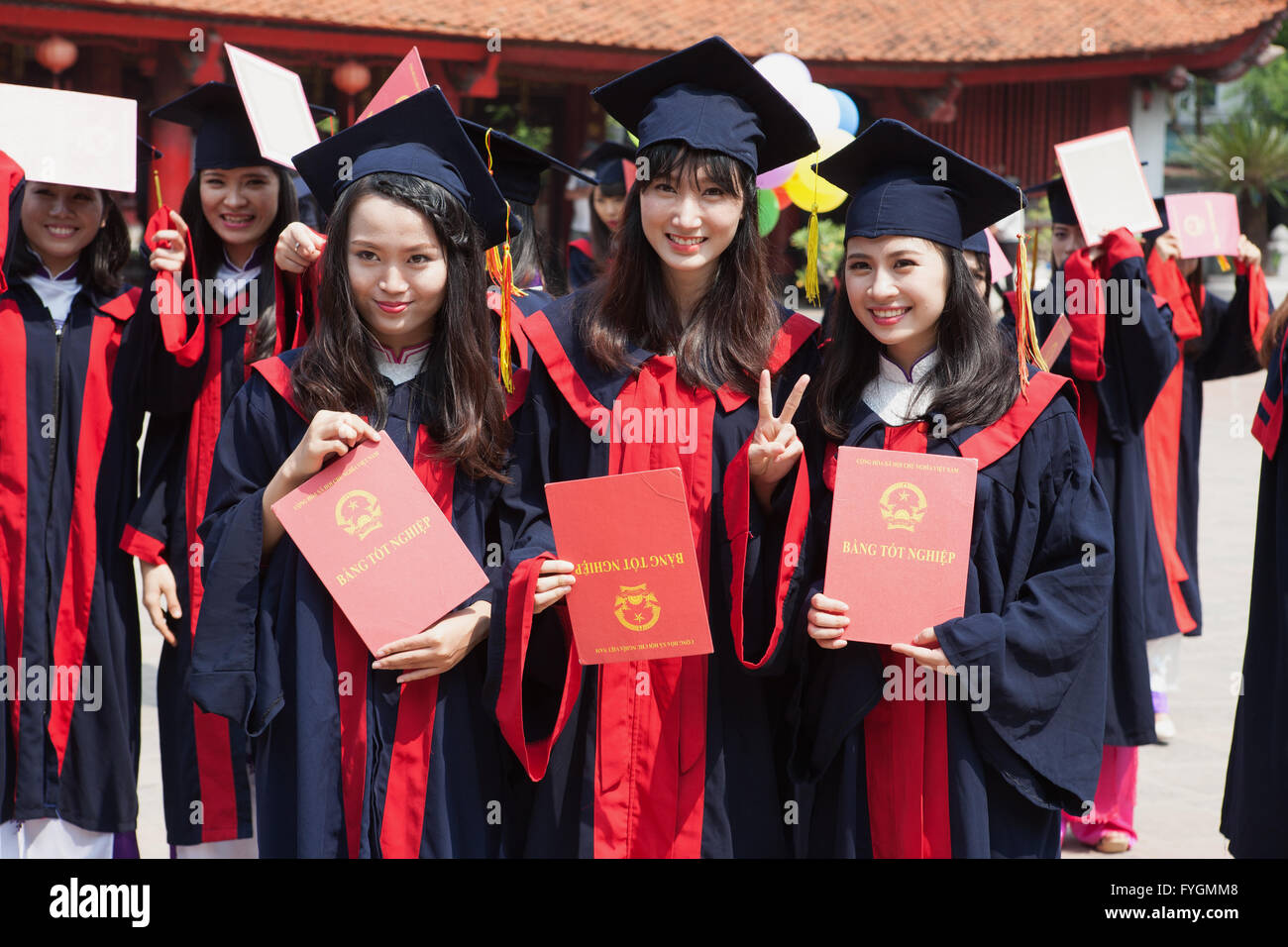 Happy female students celebrating their graduation at the Temple of Literature, Hanoi, Viet Nam Stock Photo