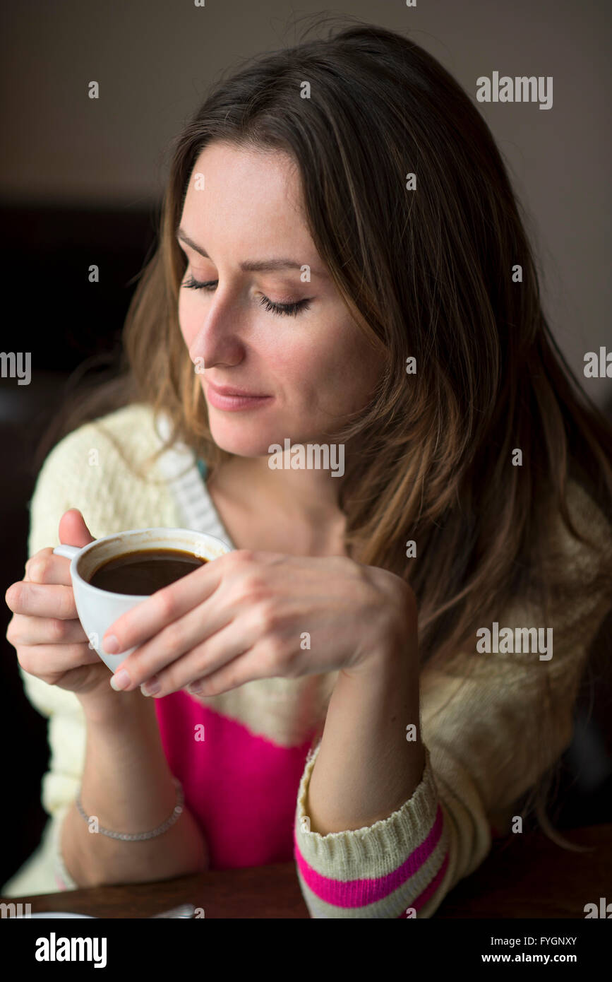 Young girl, sitting in a cafe with cup of coffee Stock Photo - Alamy