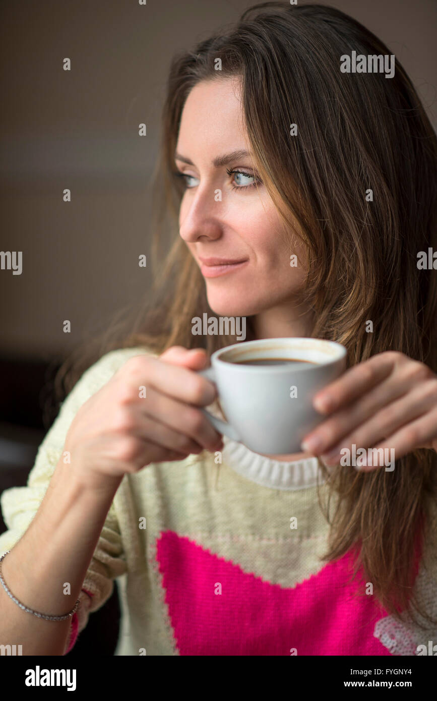 Young girl, sitting in a cafe with cup of coffee Stock Photo - Alamy