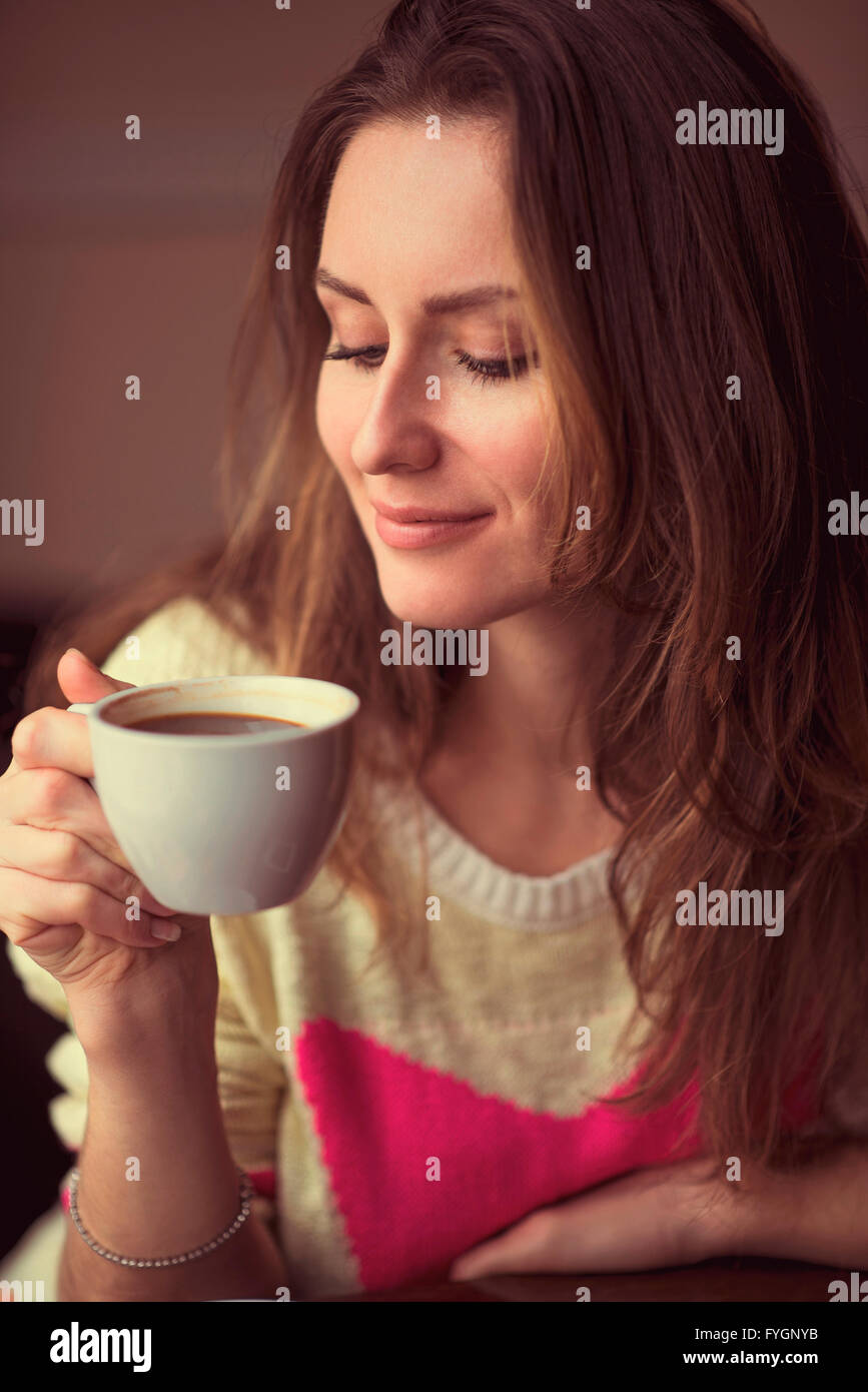 Young girl, sitting in a cafe with cup of coffee Stock Photo - Alamy