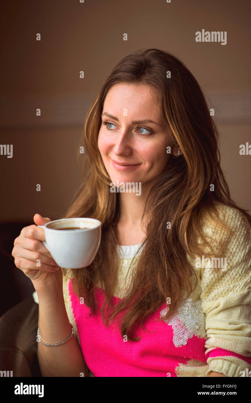 Young girl, sitting in a cafe with cup of coffee Stock Photo - Alamy