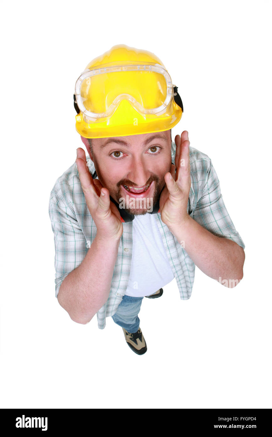 Goofy tradesman putting his hands along his face Stock Photo