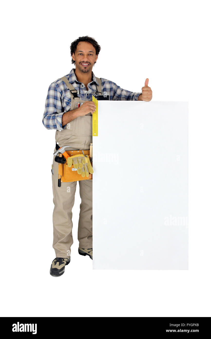 Tradesman using a try square to measure a board Stock Photo