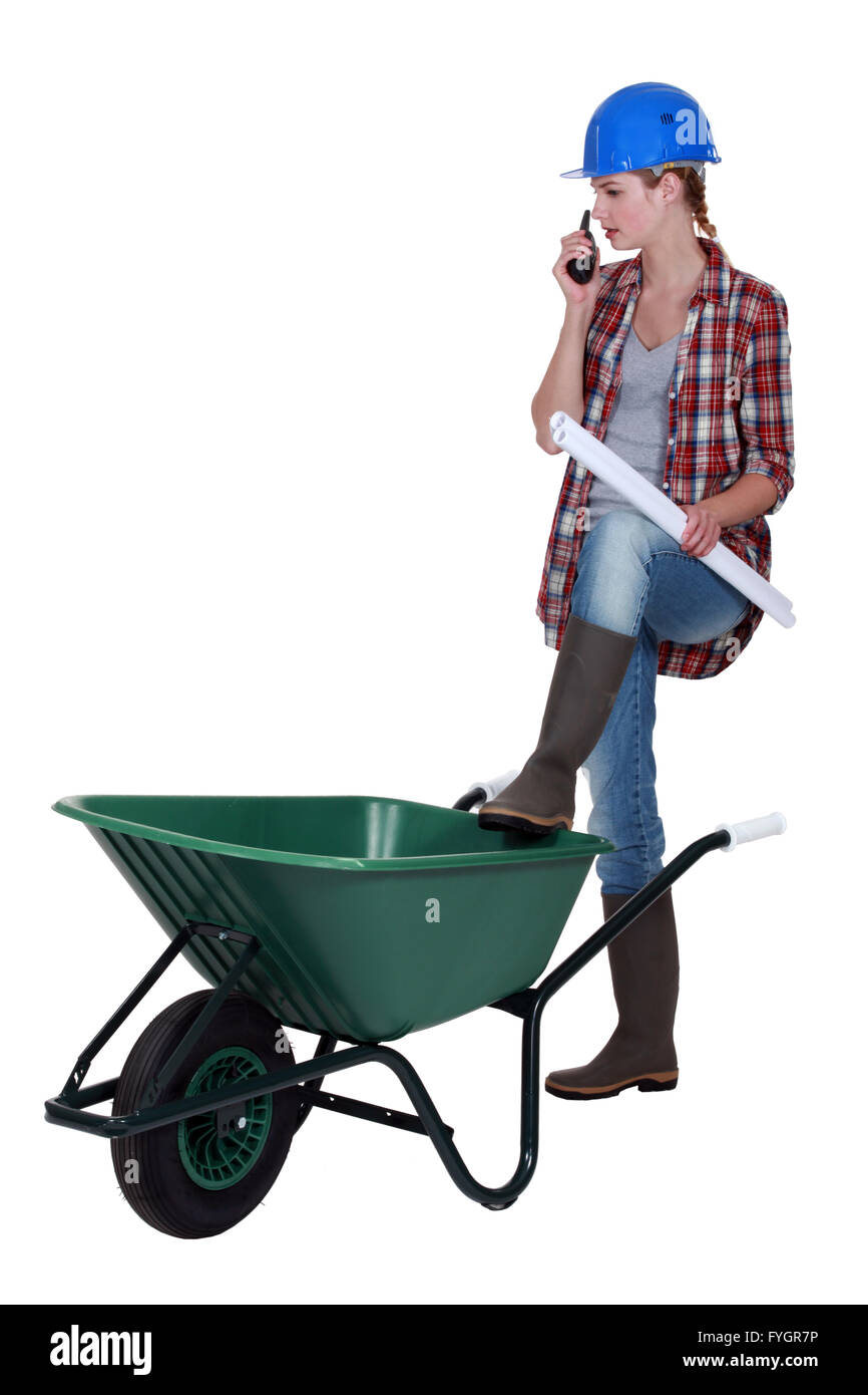 Female construction worker stood with wheelbarrow Stock Photo - Alamy