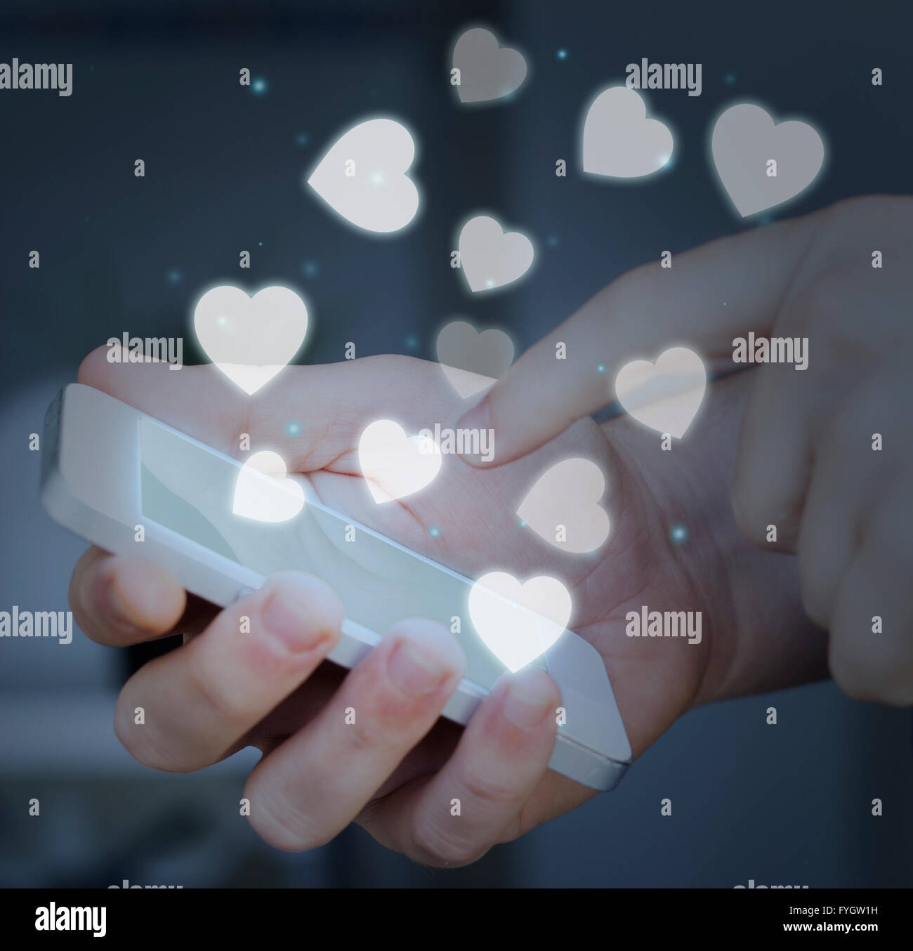 Finger touching a smartphone screen. addiction or love concept. Stock Photo