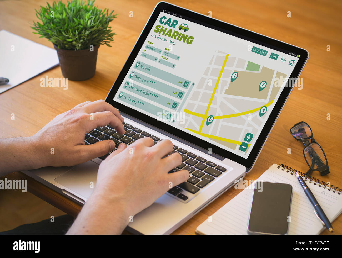 Businessman at work. Close-up top view of man working on laptop car sharing. All screen graphics are made up. Stock Photo