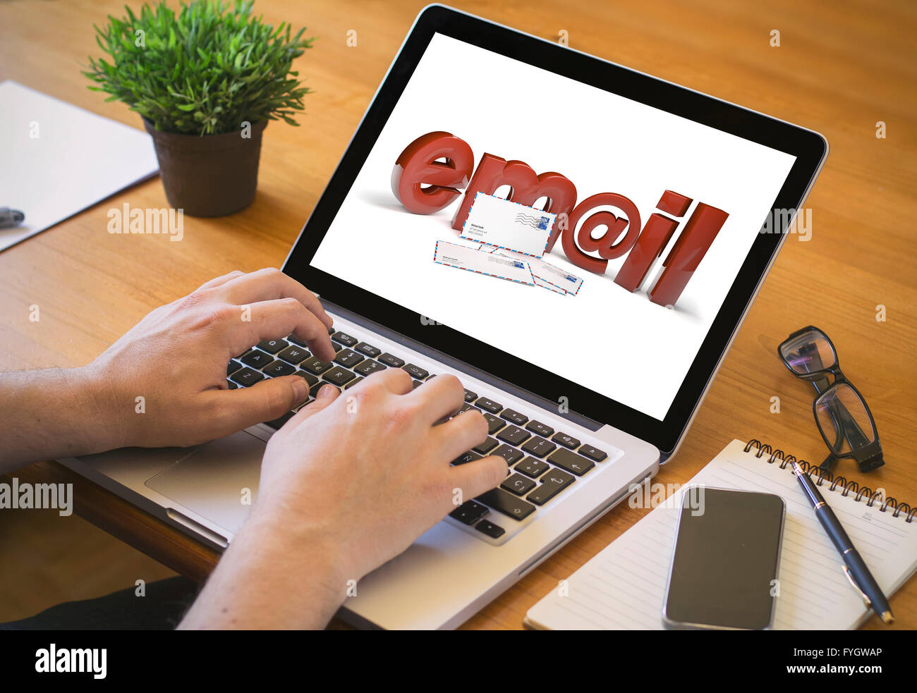 email concept. Close-up top view of man working on laptop. all screen graphics are made up. Stock Photo