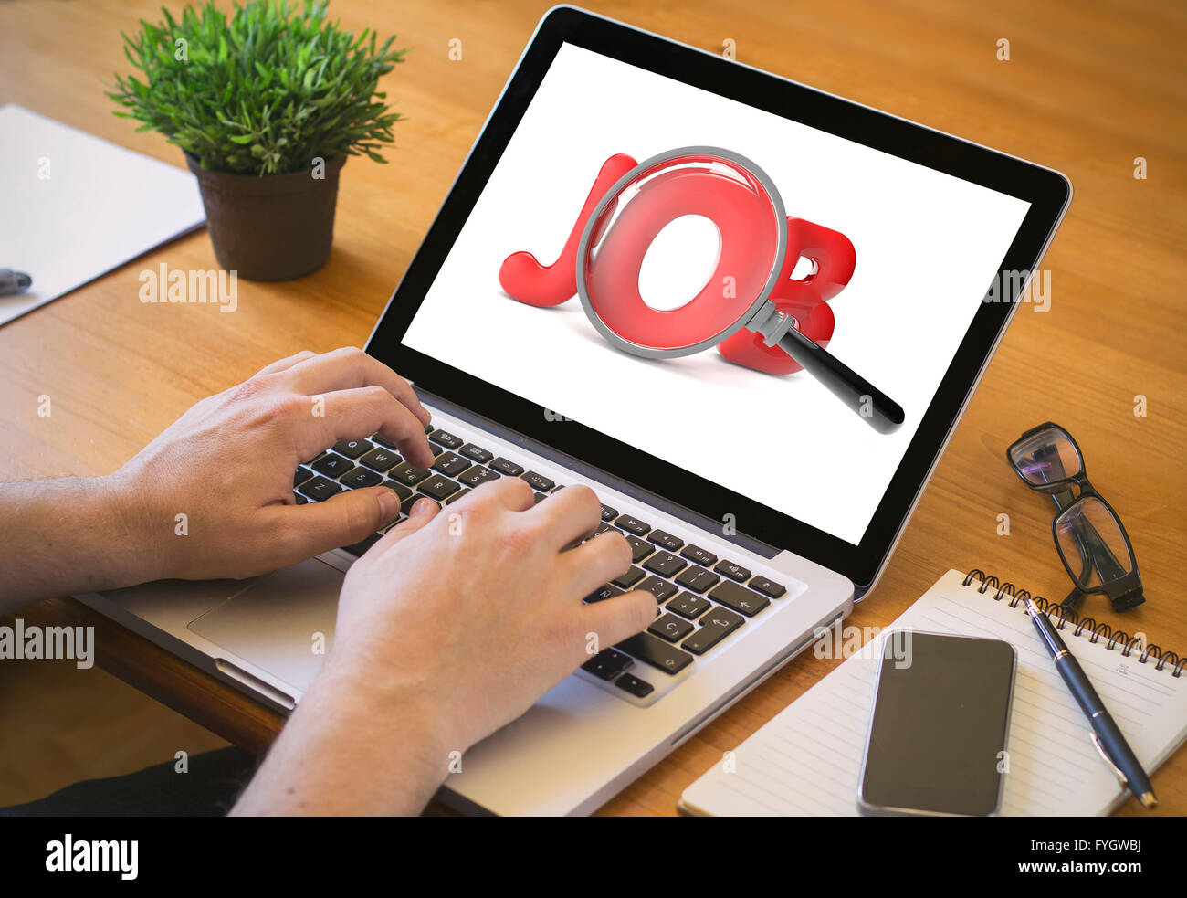 job search concept. Close-up top view of man working on laptop. all screen graphics are made up. Stock Photo