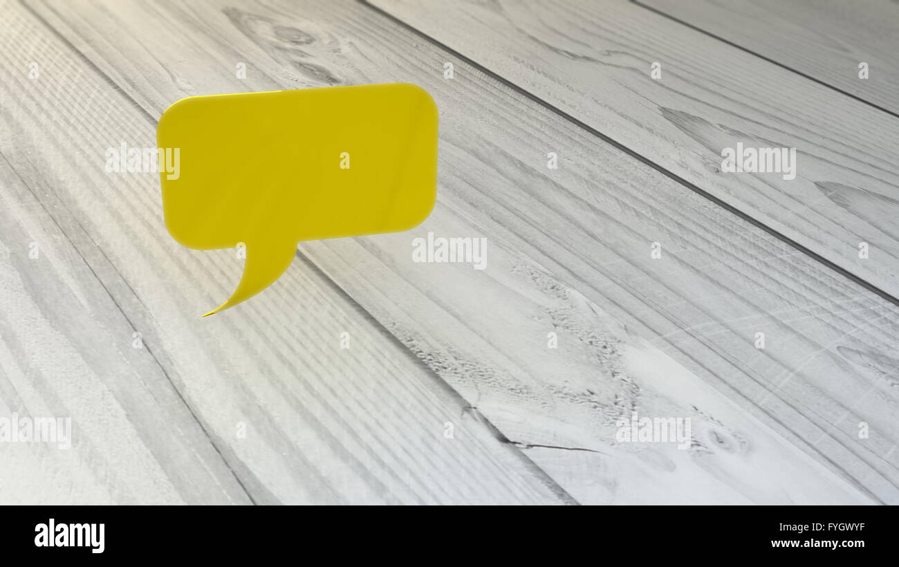 yellow speech bubble over wooden desk Stock Photo Alamy