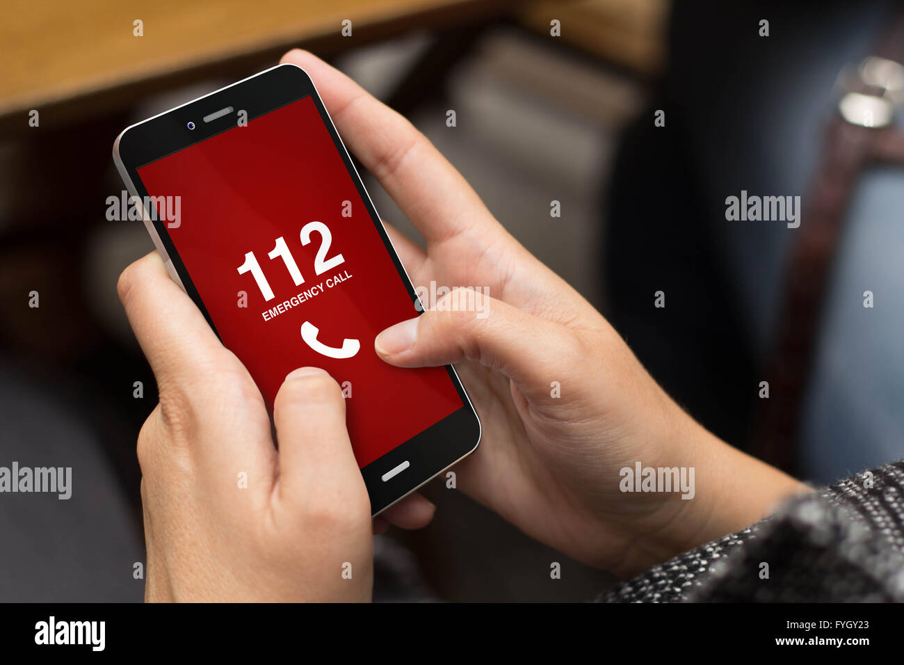 emergency concept girl using a digital generated phone with emergency call on the screen. All