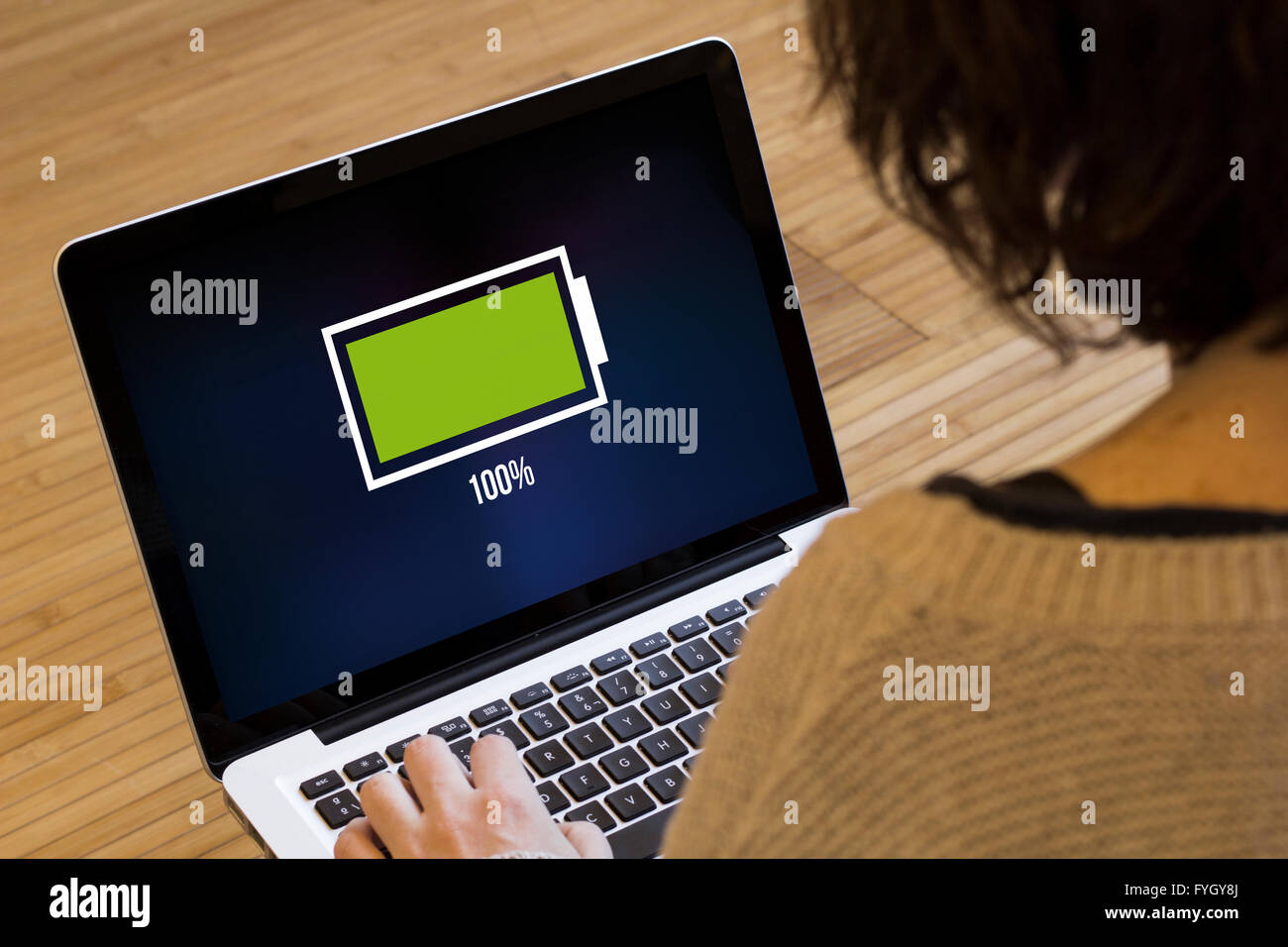 energy concept: full battery on a laptop screen. Screen graphics are made up. Stock Photo