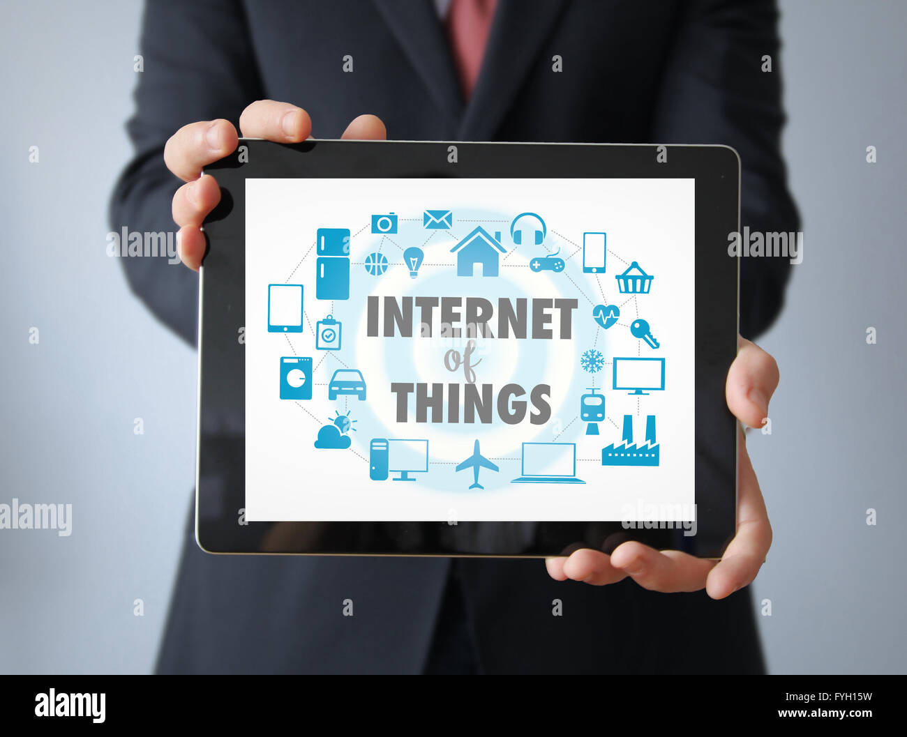 Technology Concept: Businessman with internet of things graphic on the screen. All graphics are made up. Stock Photo
