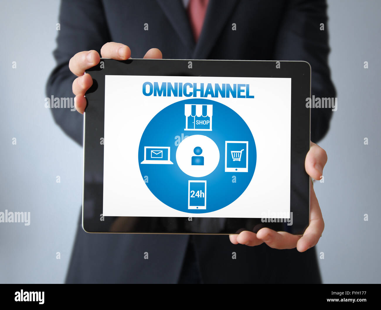 E-commerce Concept: Businessman with omnichannel on the screen. All graphics are made up. Stock Photo