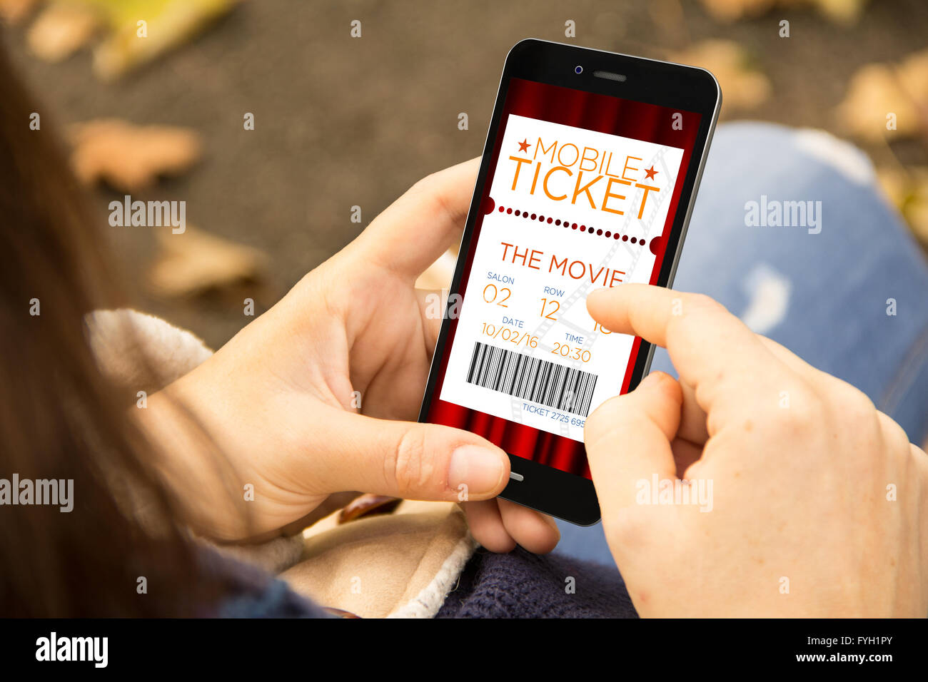 business concept: young woman with online cinema tickets phone at the park. All screen graphics are made up. Stock Photo