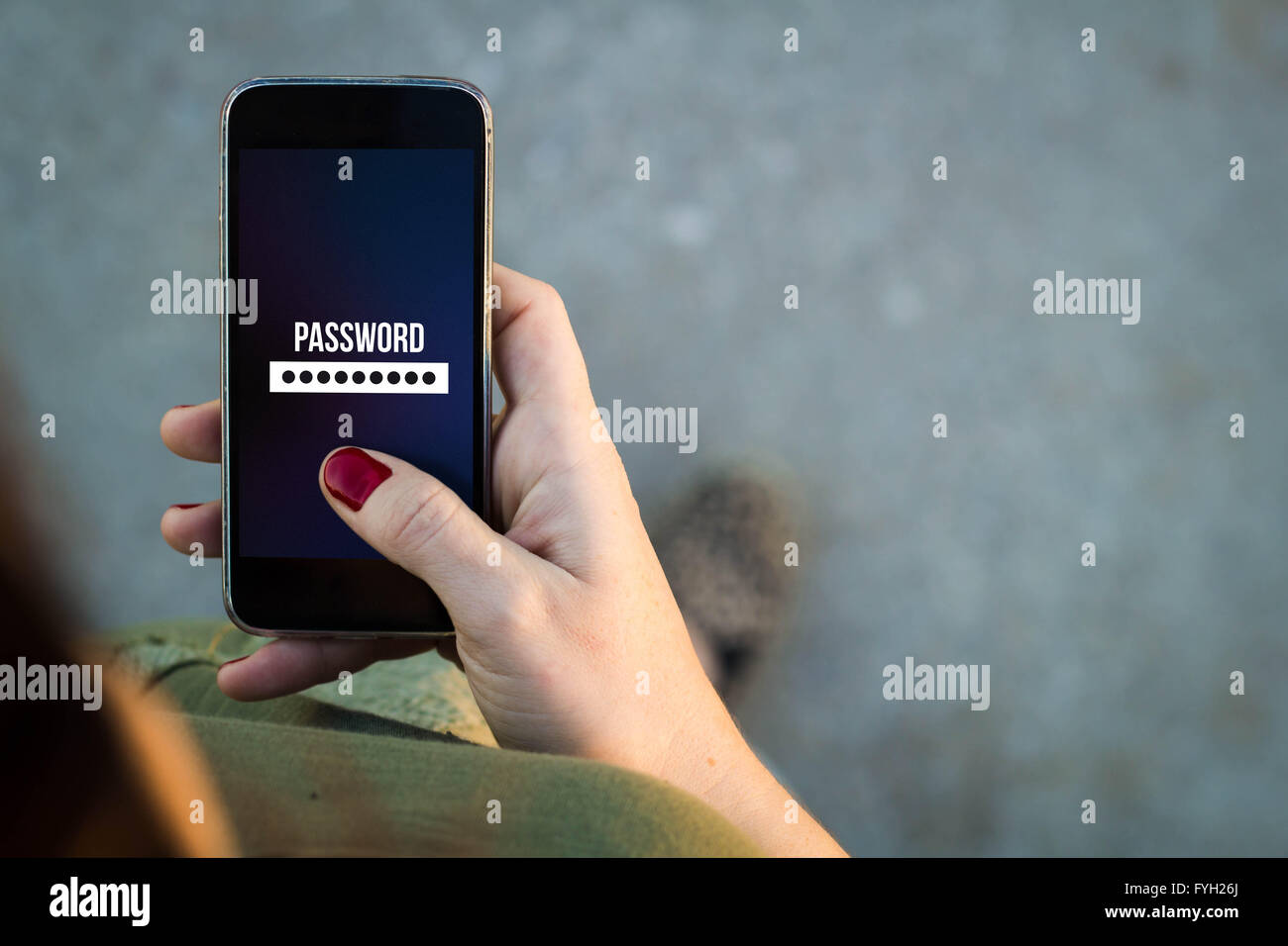 Top view of woman walking in the street using her mobile phone with password screen with copyspace. All screen graphics are made Stock Photo