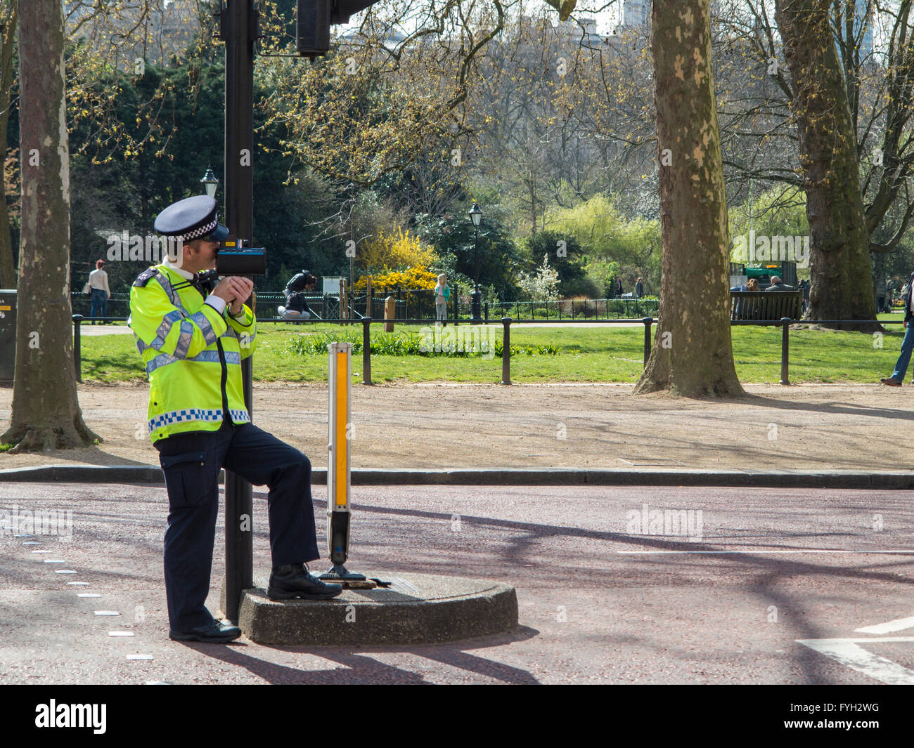 A policeman checks for speeding cars on the Mall in central London Stock Photo