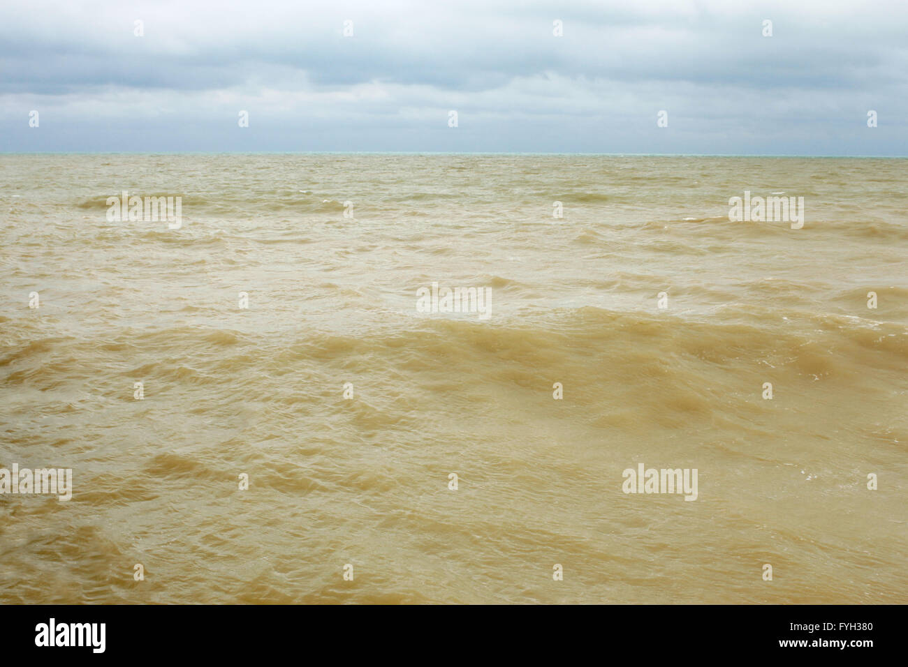 Sandy seawater after the storm Stock Photo